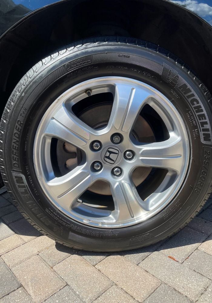 Restored car wheel and tire after mobile detailing