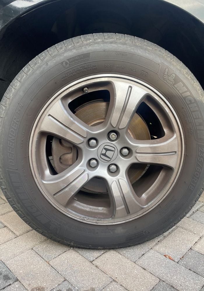 Restored car wheel and tire after mobile detailing